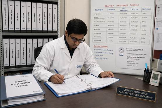 Laboratory quality manager reviewing best practices documentation binders in a Bangalore NABL-accredited research laboratory
