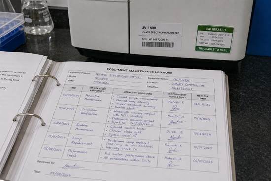 Laboratory maintenance schedule and calibration calendar on a whiteboard in a Bangalore quality-controlled research institution