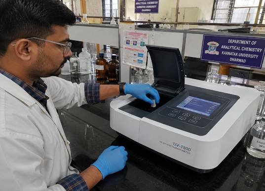 Researcher operating an HPLC system as part of analytical instruments setup in a Karnataka pharma quality control lab