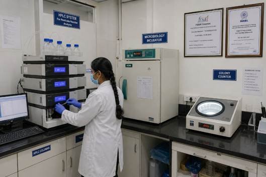 Food laboratory testing equipment in a Bangalore FSSAI-approved testing facility — HPLC system and incubators visible in working food QC lab