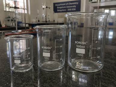 Borosilicate glass laboratory beakers with clear markings on a Bangalore chemistry lab bench