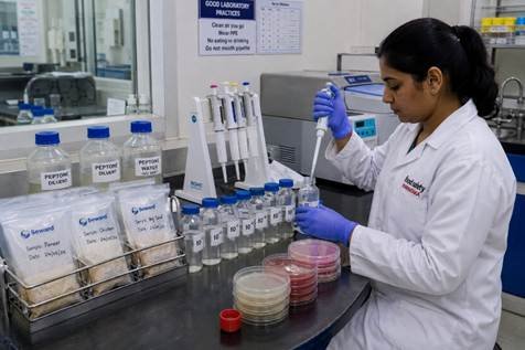 Food microbiologist preparing serial dilutions of a food sample for total viable count testing in a Karnataka food testing lab